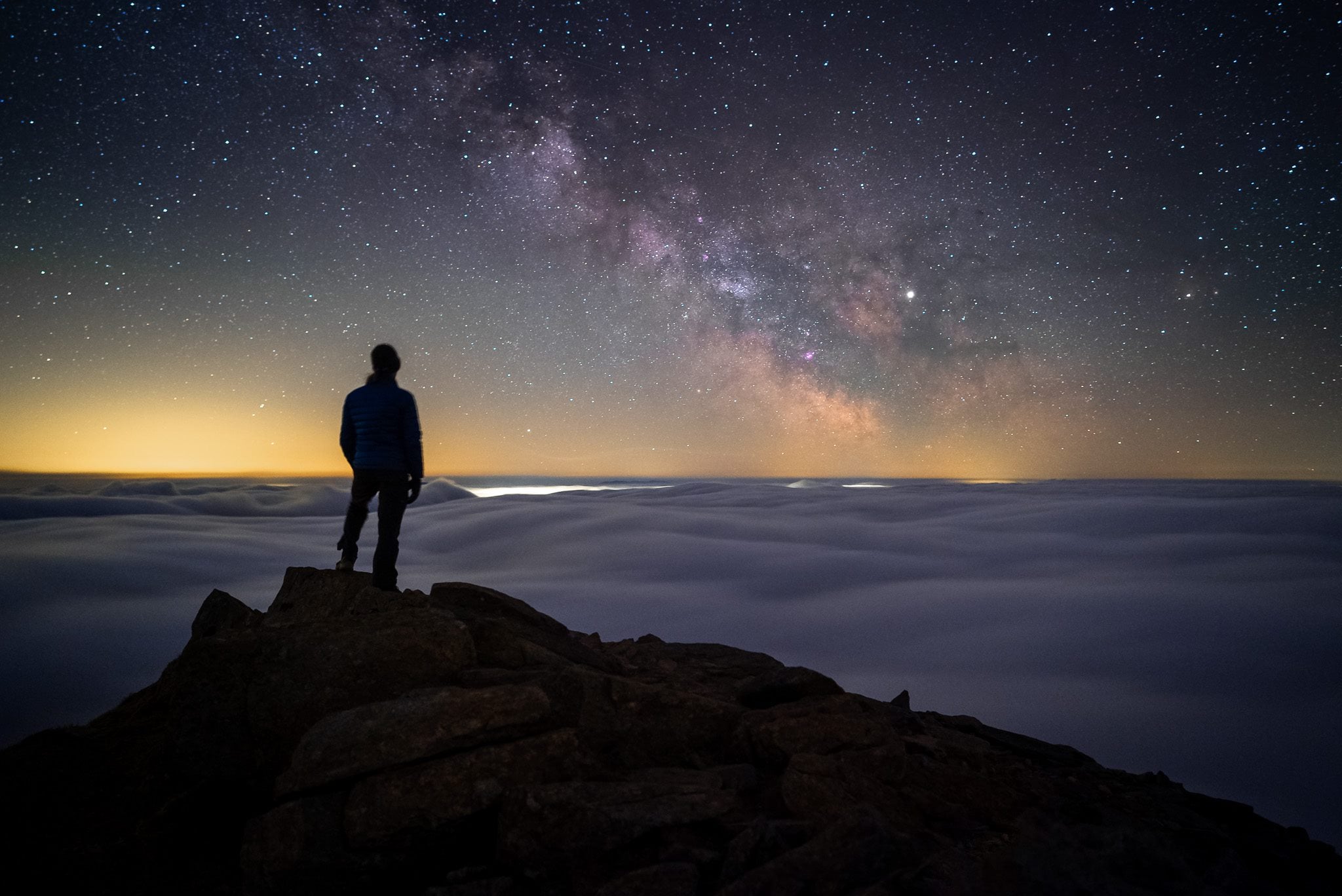 Standing on a mountain top under the Milky Way